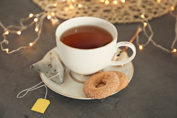 Cup with delicious tea on table