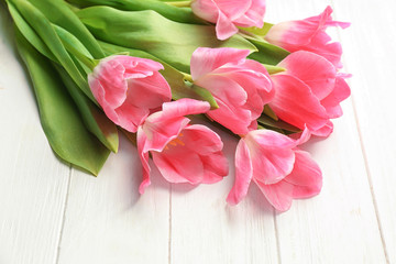 Beautiful tulips on white wooden background