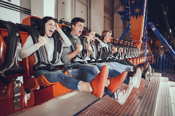 Young people are shocked by the speed of the carousel.