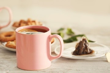 Cup of tasty hot tea on table