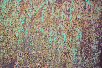 Photo of a rusty metal previously painted with green paint