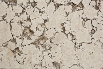 The texture of the stone slab in cracks and stains.