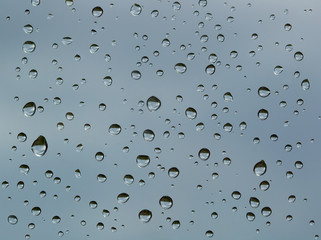 Textured water drops on the window glass.