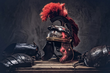 Complete combat equipment of the ancient Greek warrior lie on a box of wooden boards.