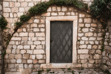 Fototapeta na wymiar Old Door and Stone Wall in Dubrovnik, Croatia