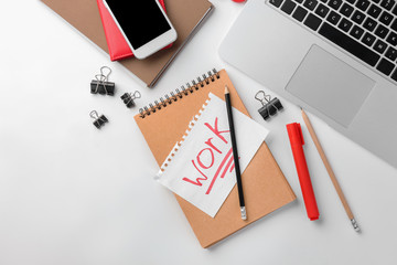 Laptop, smartphone and stationery on white background, flat lay. Workplace table composition