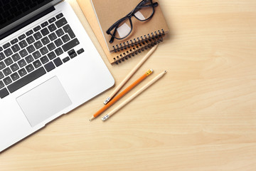 Laptop and stationery on light background, flat lay. Workplace table composition