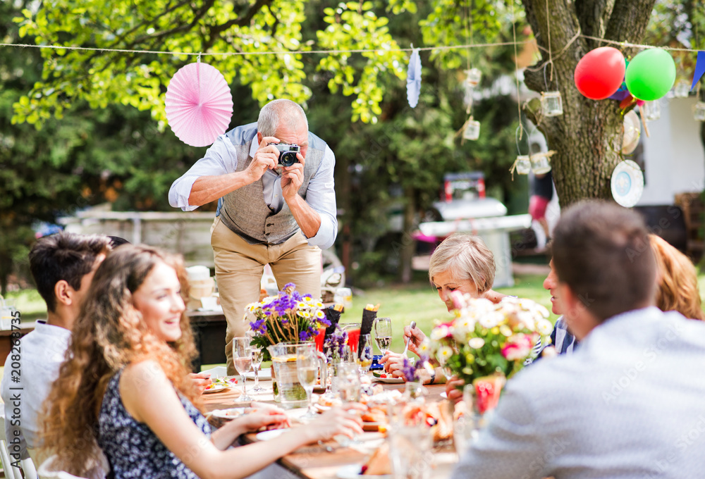 Wall mural family celebration or a garden party outside in the backyard.