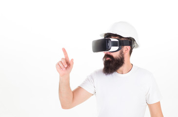 Man with beard in protective helmet using digital touch screen. Brutal bearded construction boss wearing VR headset isolated on white background. Bearded builder experiencing virtual reality