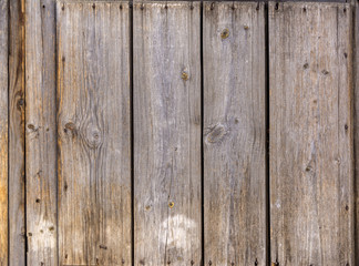 Texture. The old unpainted wall of the house. Old wooden fence.