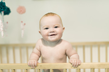 beautiful baby girl in the crib at home