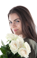 Close up cropped portrait of charming cheerful hispanic woman with natural makeup having bouquet of white roses in hands looking at camera isolated on white background. 