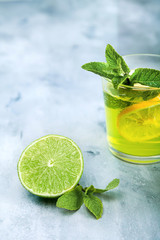 Fresh mojito cocktail on background. Coctail with lime and lemon. Place for text.