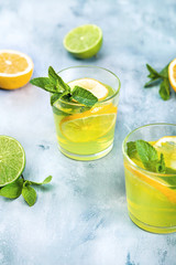 Fresh mojito cocktail on background. Coctail with lime and lemon. Place for text.