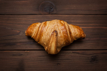 beautiful croissant on a wooden background