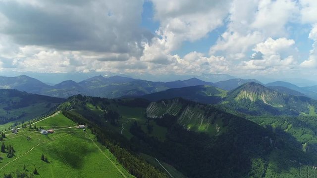 Aerial panoramic view of Austrian Alps near Salzburg in summer, beautiful scenery with majestic lush green slopes and peaks of mountains - picturesque landscape of Austria from above, Europe 