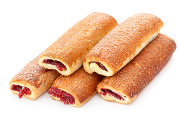 Sweet baked rolled tubes with sugar and jam, selective focus
