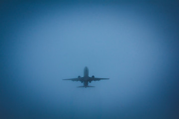 The plane flies in the sky. Aircraft on blue sky background