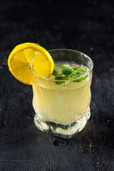 Yellow alcohol drink in glass on black background