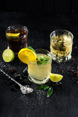 A few of drinks in glasses on black background