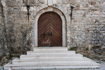 Fototapeta na wymiar Wooden Door and Stone Building, Montenegro