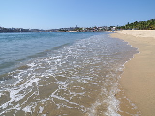 Spectacular sandy beach at bay of ACAPULCO city in Mexico with luxury panoramic view and waves of...