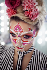 Young beautiful woman with skull makeup. Mexican day of the dead