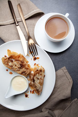 Apple strudel with vanilla cream and coffee