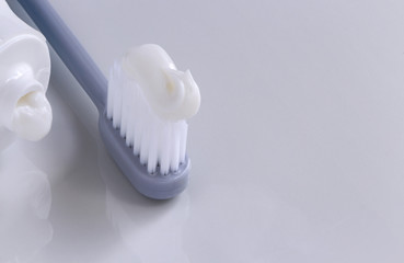 Fototapeta na wymiar Toothbrush and toothpaste tube on the white table.