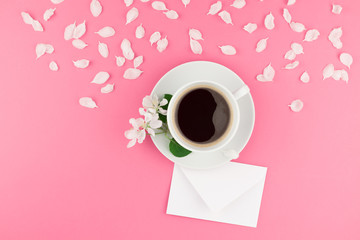 Flat lay of coffee, letter mockup and white petals