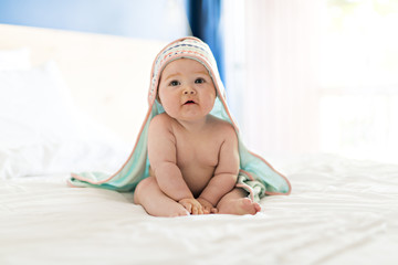 beautiful baby girl in the bed at home with