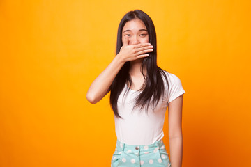 Young Asian woman close her mouth with hand.