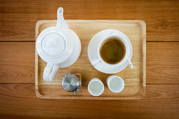  top view, White coffee cup and tea pot on wooden Tray, wooden table