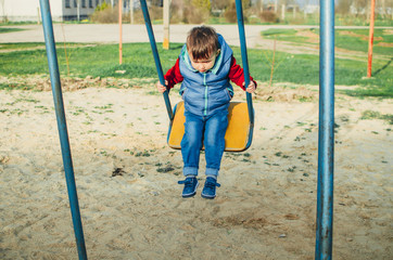 ittle baby swinging on the swing and not afraid