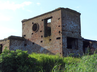 Old ruined red brick building with no Windows
