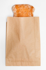 traditional white bread in brown kraft wrapper in white background
