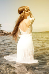 Fototapeta na wymiar Young woman standing in the ocean