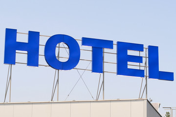 sign "Hotel" on a building's roof