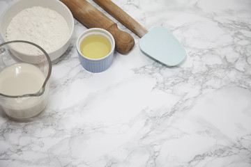 flour, almond milk and oil and rolling pin