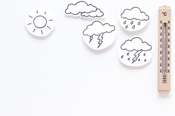 Weather forecast concept. Air temperature. Termometer among cloud and lightening, sun, rainy clouds...