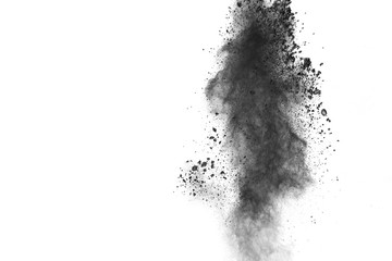 Black powder explosion. The particles of charcoal splatter on white background. Closeup of black dust particles splash isolated on  background.