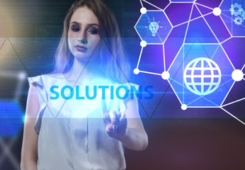 The concept of business, technology, the Internet and the network. A young entrepreneur working on a virtual screen of the future and sees the inscription: Solutions
