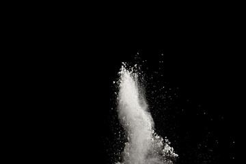 Bizarre forms of  white powder explosion cloud against dark background. Launched white particle splash on black background.