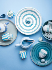 Blue pastel ceramic tableware crockery set on abstract background