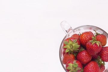 Strawberry in a glass mug on a white background athe top view