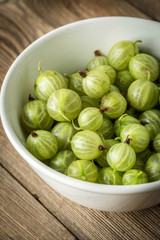 Fresh gooseberry in a white bowl.