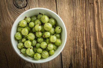 Fresh gooseberry in a white bowl.