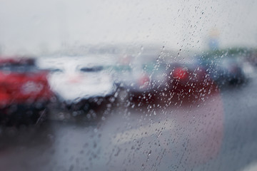 rain on a window and road with cars