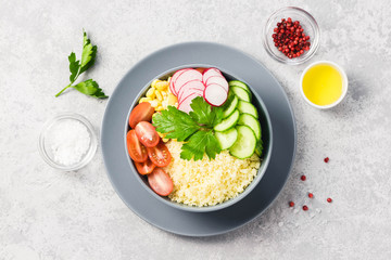 Vegan couscous summer vegetables buddha bowl. Top view, space for text.