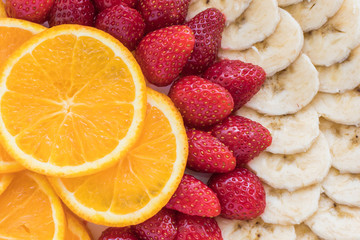 Colorful mix of fresh fruits. Orange, banana, strawberry. Vitamins Summer dessert. 